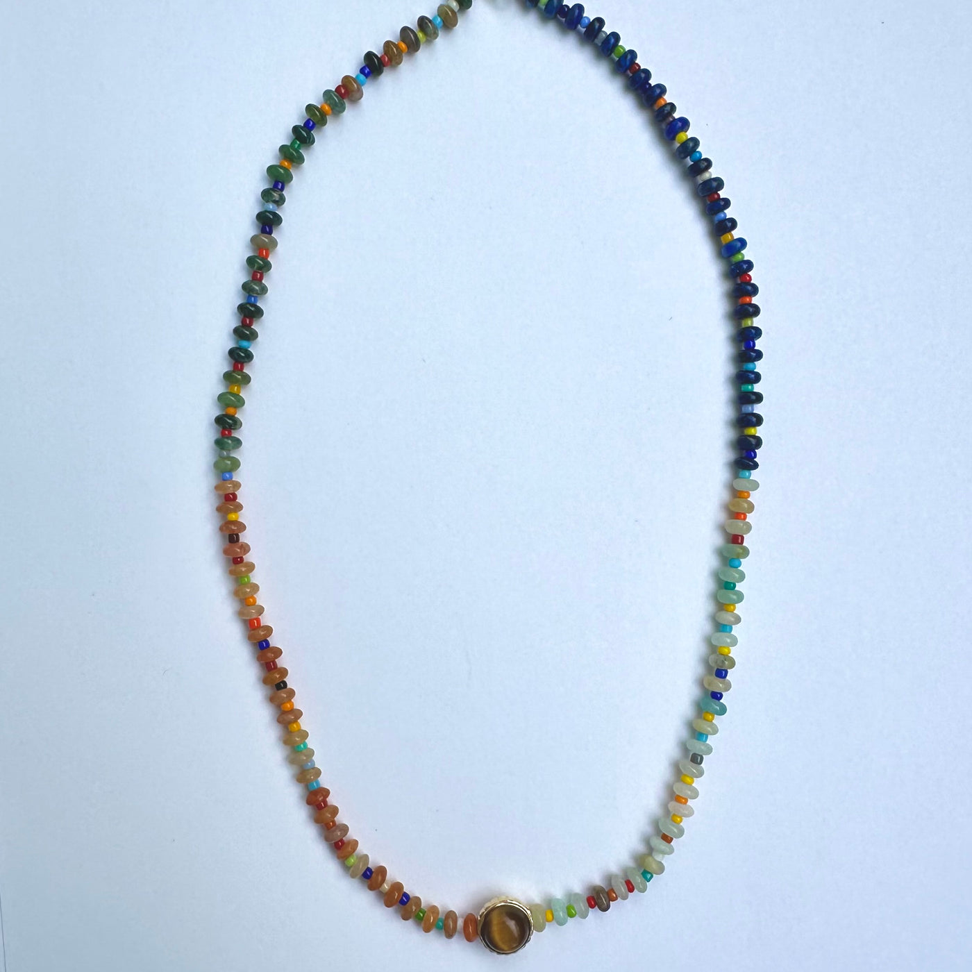 luis morais multicolored beaded 16" necklace 14k gold skull toggle clasp with collared cabochon tigers eye and balance symbole