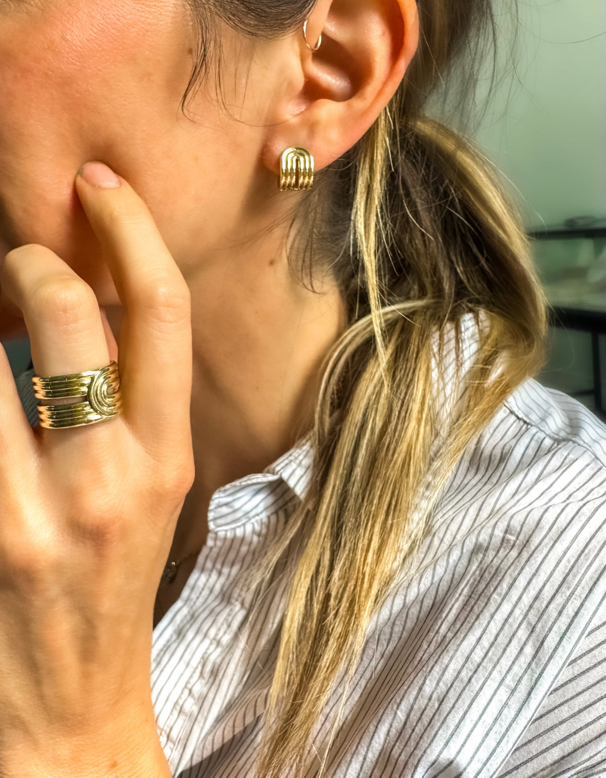 Alexa Sidaris 14k yellow gold radiant loop earrings. These hoops are a mix between a cuff and a huggie with a clip closure