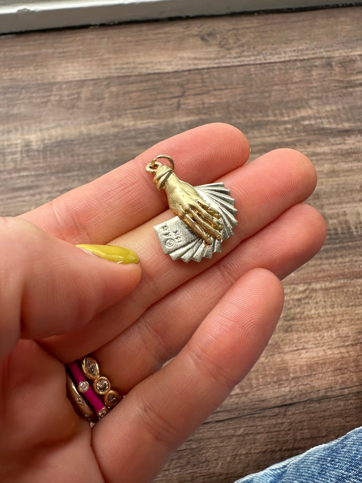 Estate & Vintage 14k yellow and white gold charm, hand holding a set of playing cards adorned with red and black enamel. Vegas, poker, Texas hold 'em, Black Jack