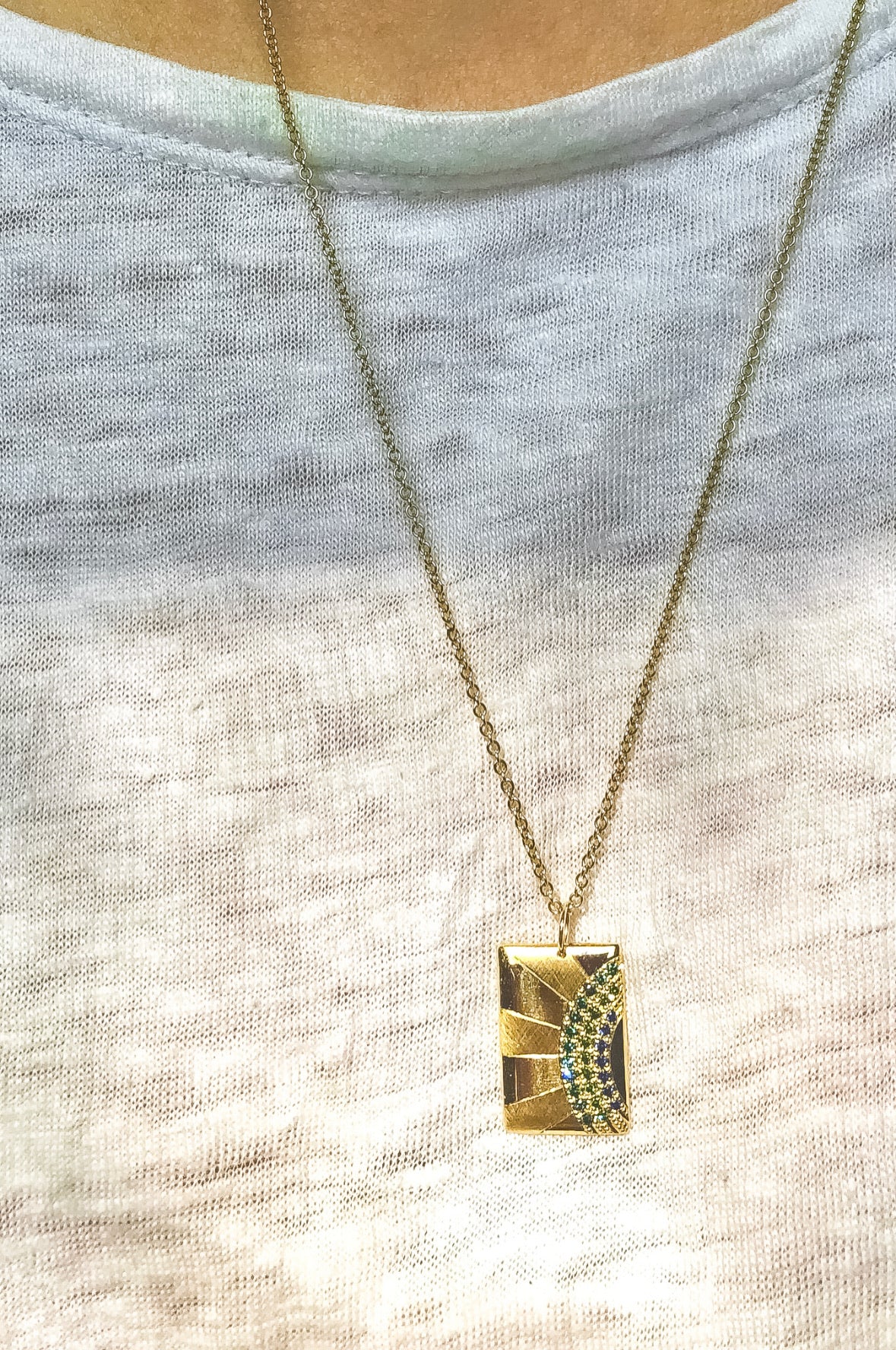 Julez Bryant 14k gold CALS rectangular pendant with full cut round green diamonds and blue sapphires. 