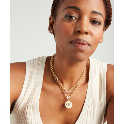 Kate Collins 14k yellow gold round disc charm pendant with a bee signifying abundance and empowerment.