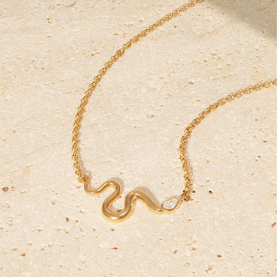 L'Atelier Nawbar 18k yellow gold chain with a snake that has a white diamond serpent head