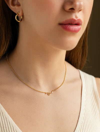L'Atelier Nawbar 18k yellow gold chain with a snake that has a white diamond serpent head