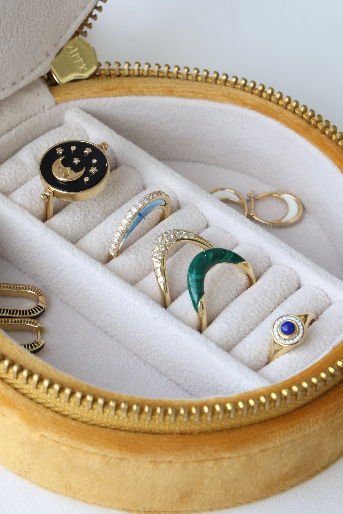 L'Atelier Nawbar velvet embroidered jewelry travel case, shown with rings and earrings inside
