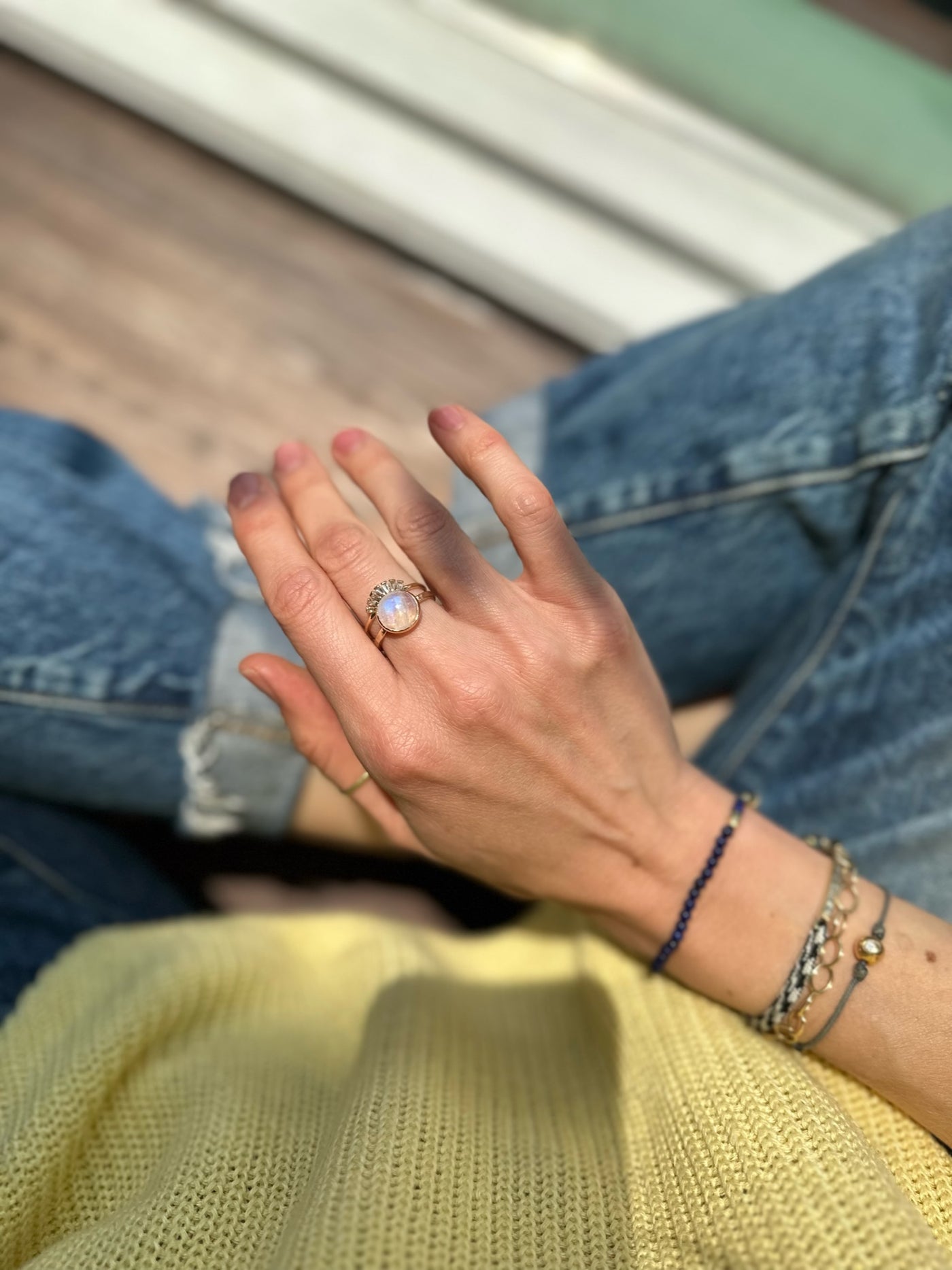 Anzie vibrant cabochon moonstone is bezel set in a  14k yellow gold hammered band