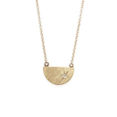 Julez Bryant 14k gold small half circle with satin finish and a single diamond, attached chain.