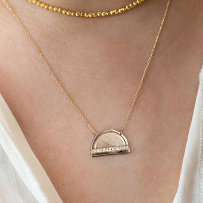 Julez Bryant 14k gold JOKI half dome necklace featuring a single horizontal row of white diamonds.
