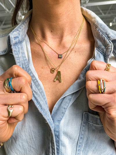 My Story 14k yellow gold small fluted initial pendant on an 18" chain.